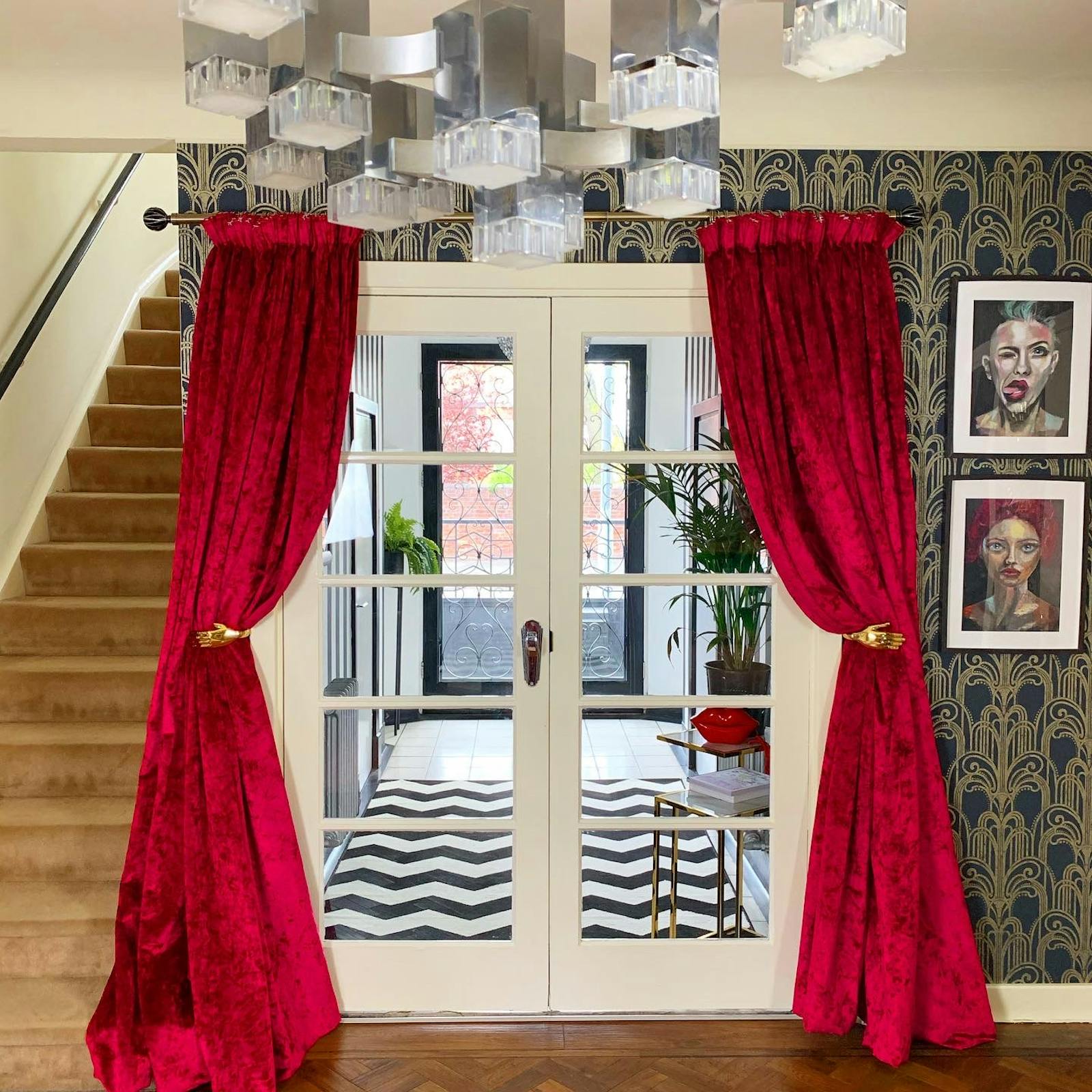 Hallway with stripes and massive red velvet curtains