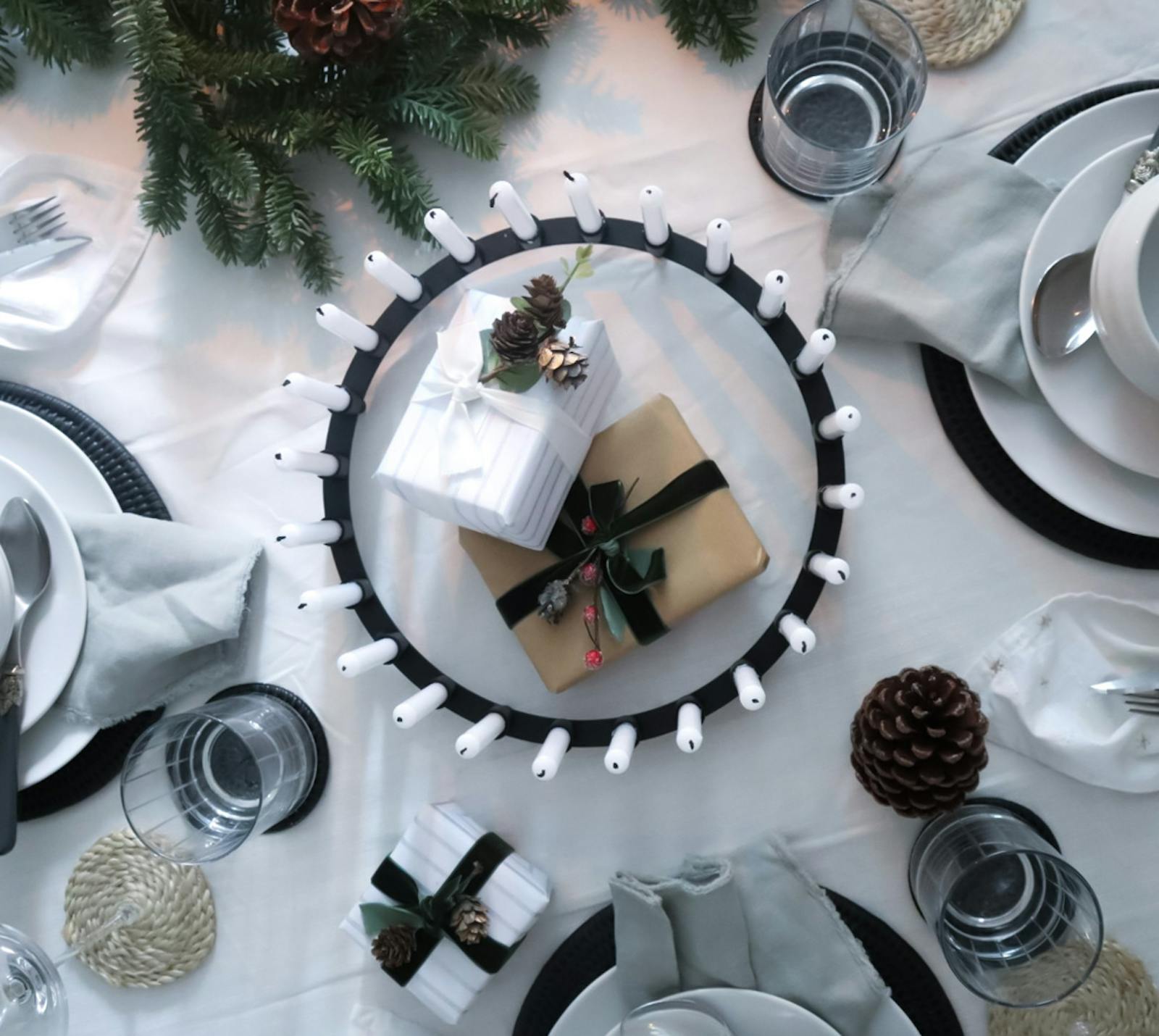 Flat lay table decoration with glasses, napkins and Christmas accents