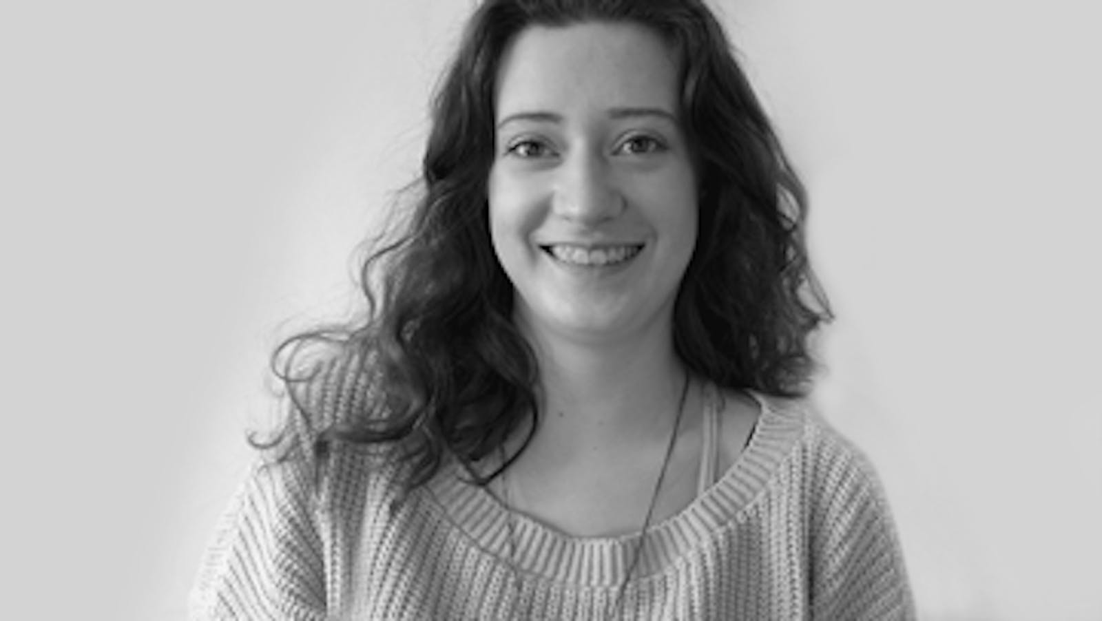 Artist (Jenna) smiling in black and white picture
