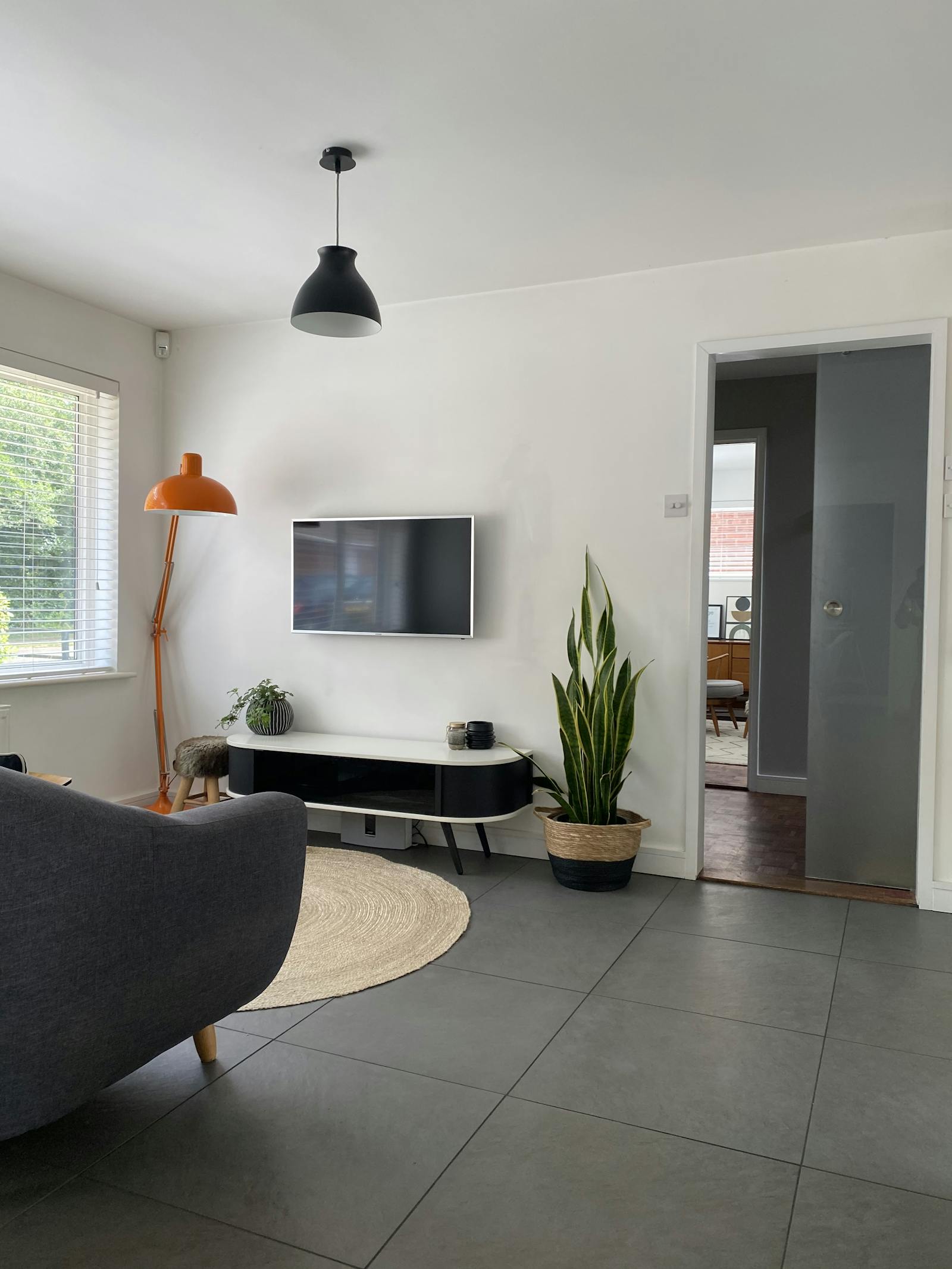 Lounge area with a small sofa and tv