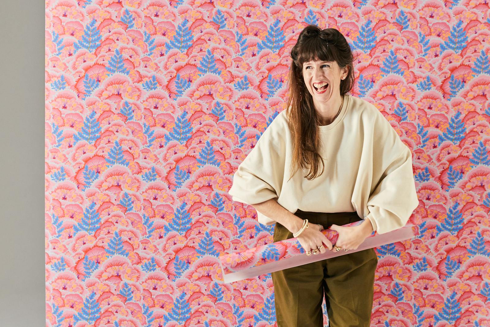 Natasha Coverdale standing in front of Lick Electric Poppies 01 wallpaper
