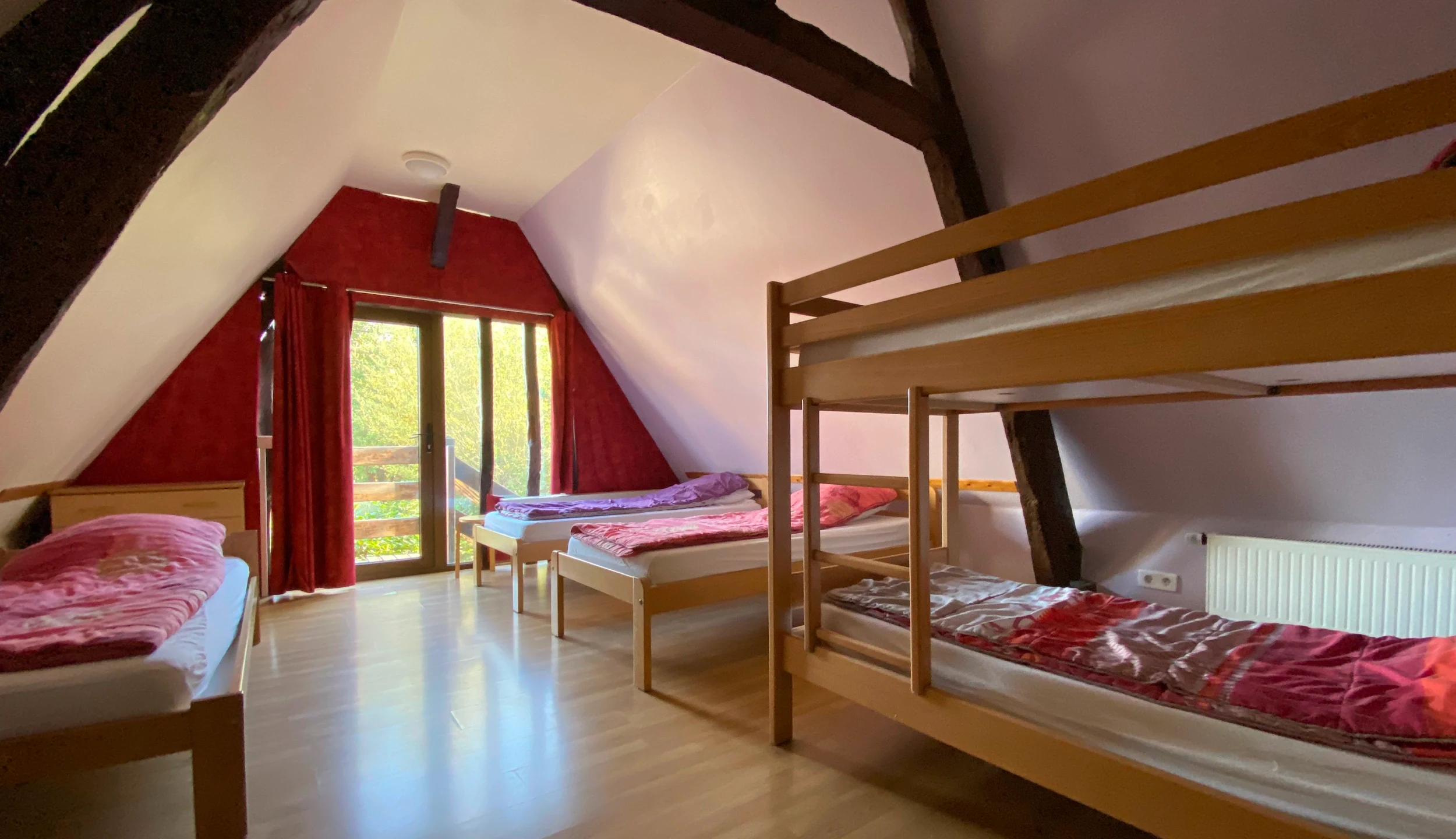 Attic bedroom with three single beds and one bunk bed