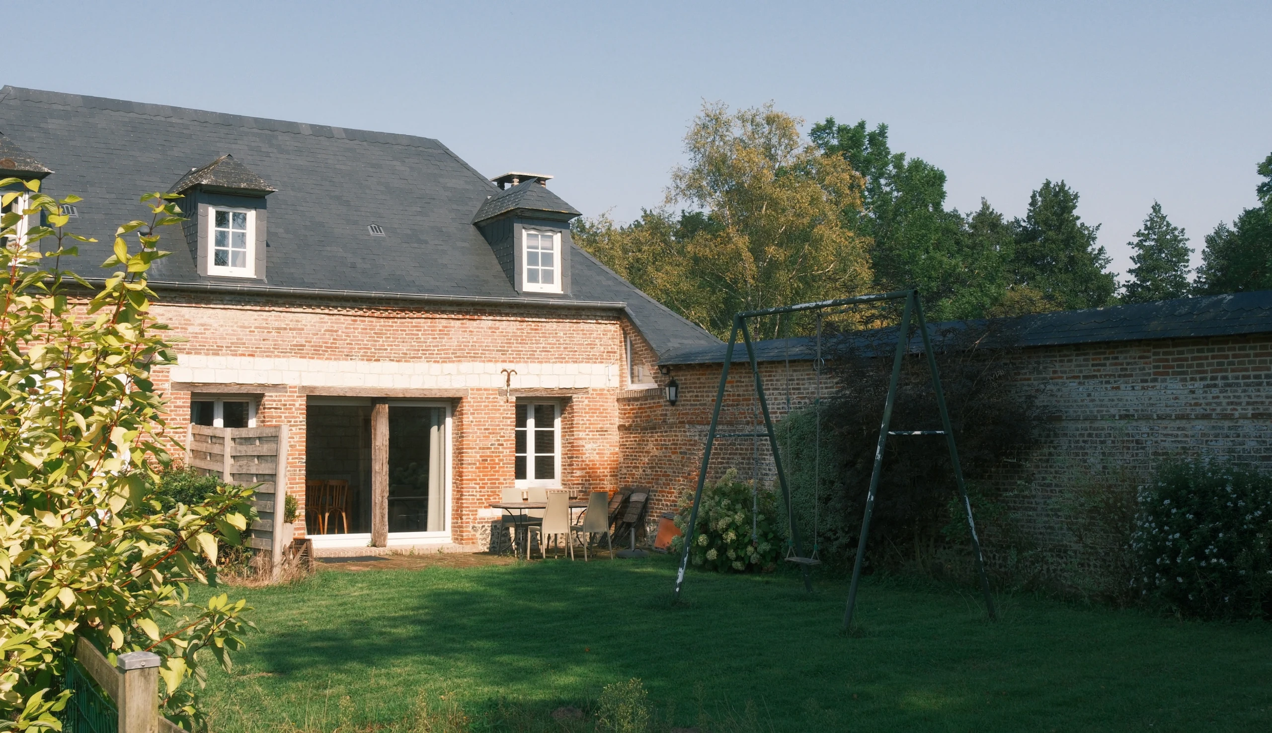 Private garden with swing and lush green lawn