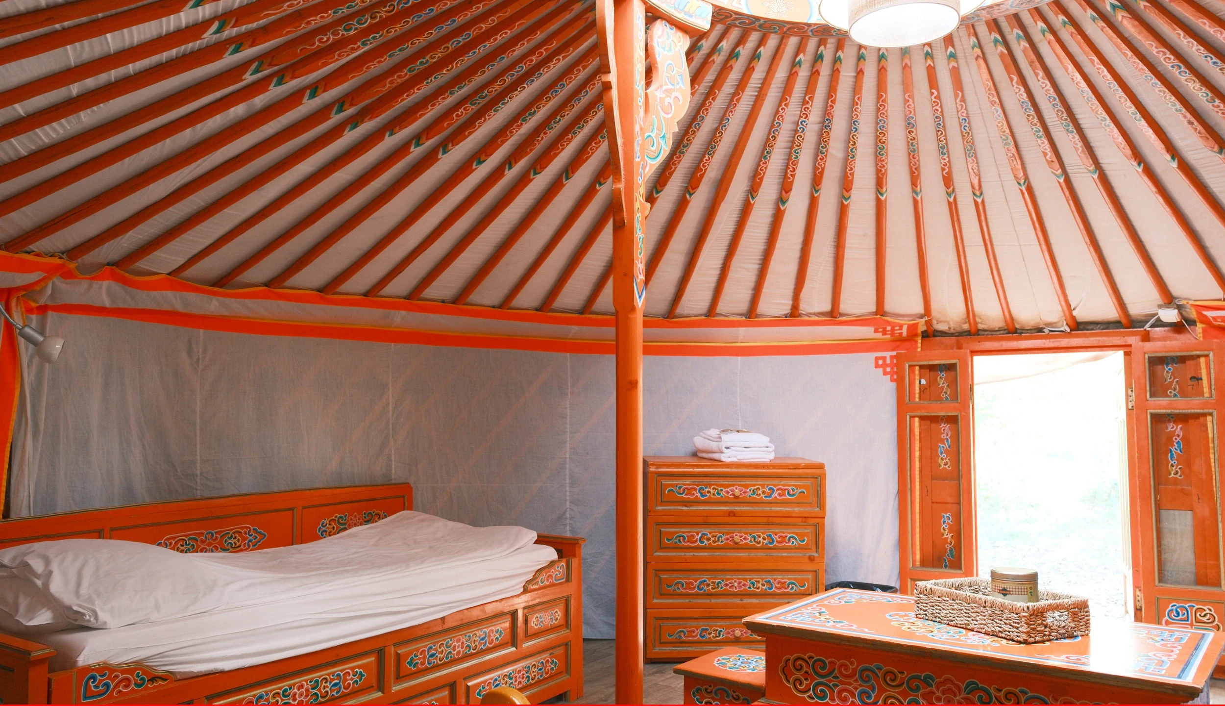 Single bed, wooden chest of drawers, orange wooden panels