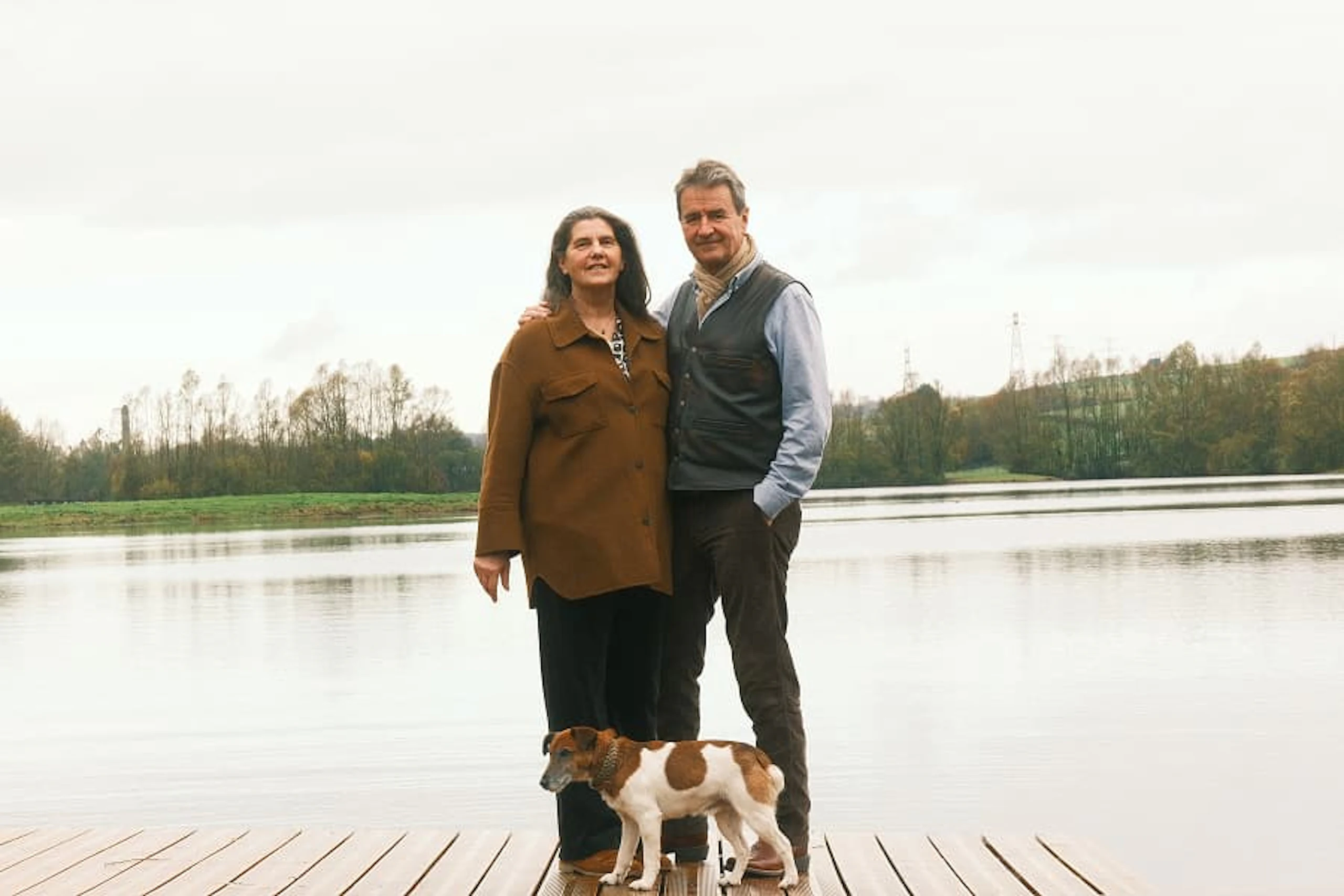 Marie-Annick and Jérôme, the owners of Lieudieu, with their dog Pepper, on one of their ponds within the estate