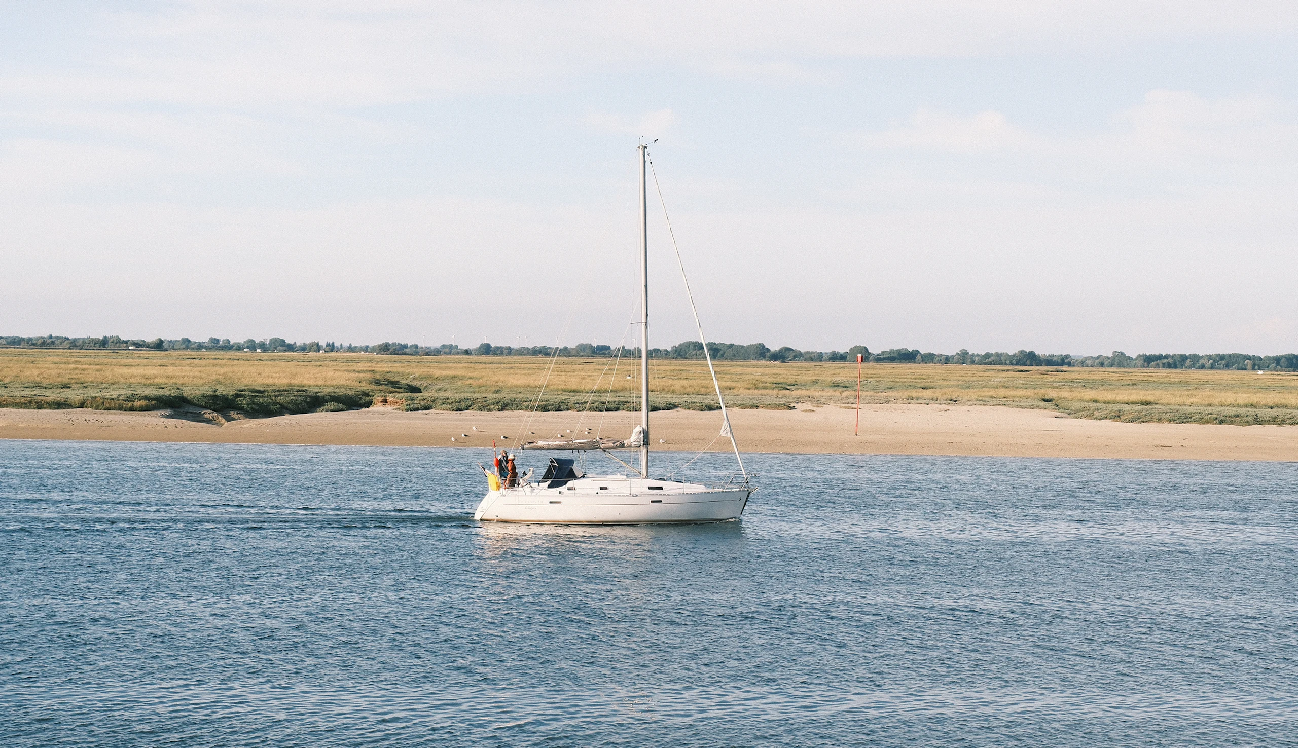 A pleasure boat passing through the bay on its way back from the sea