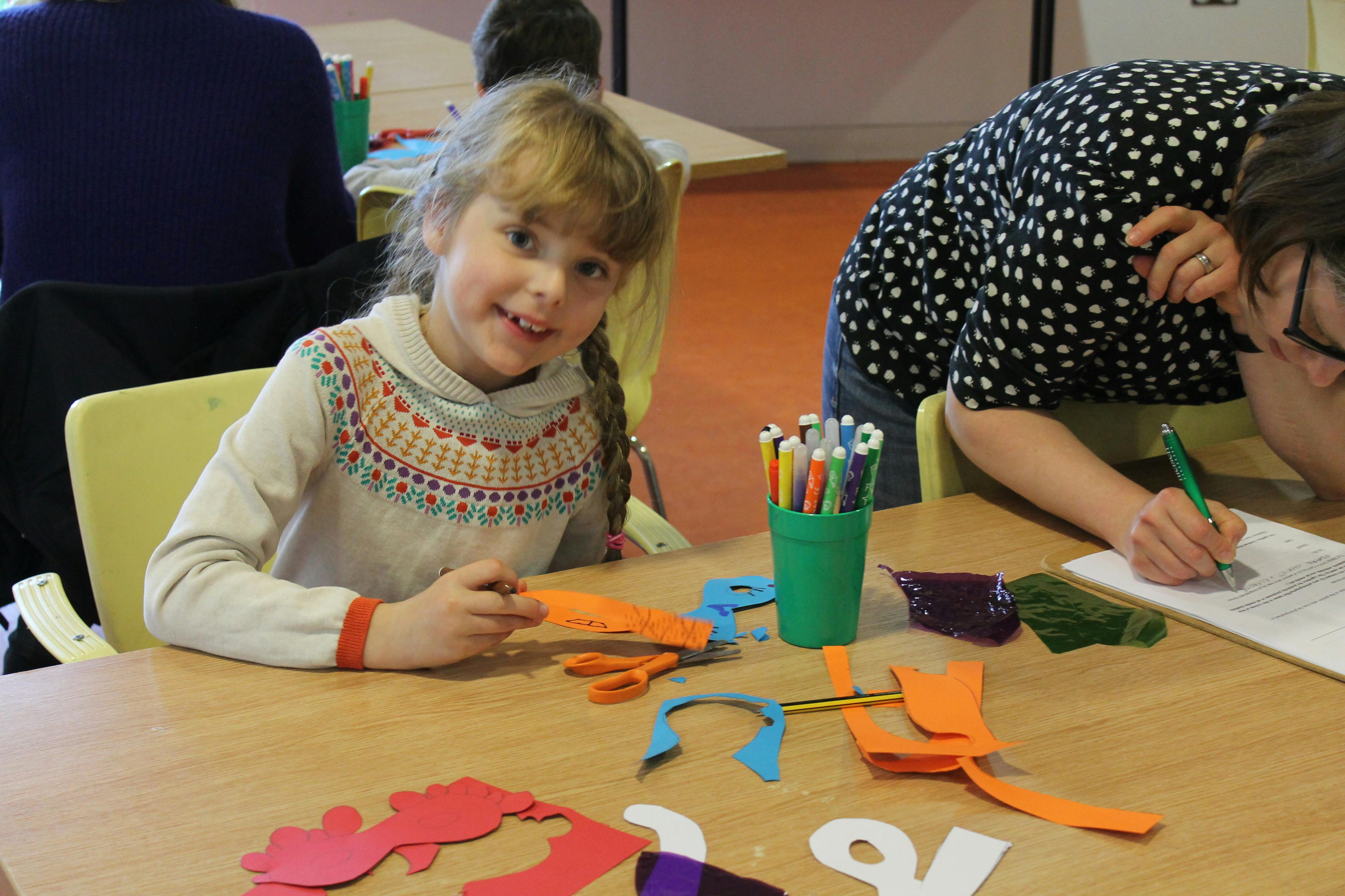 Young girl doing arts and crafts in the children's workshop