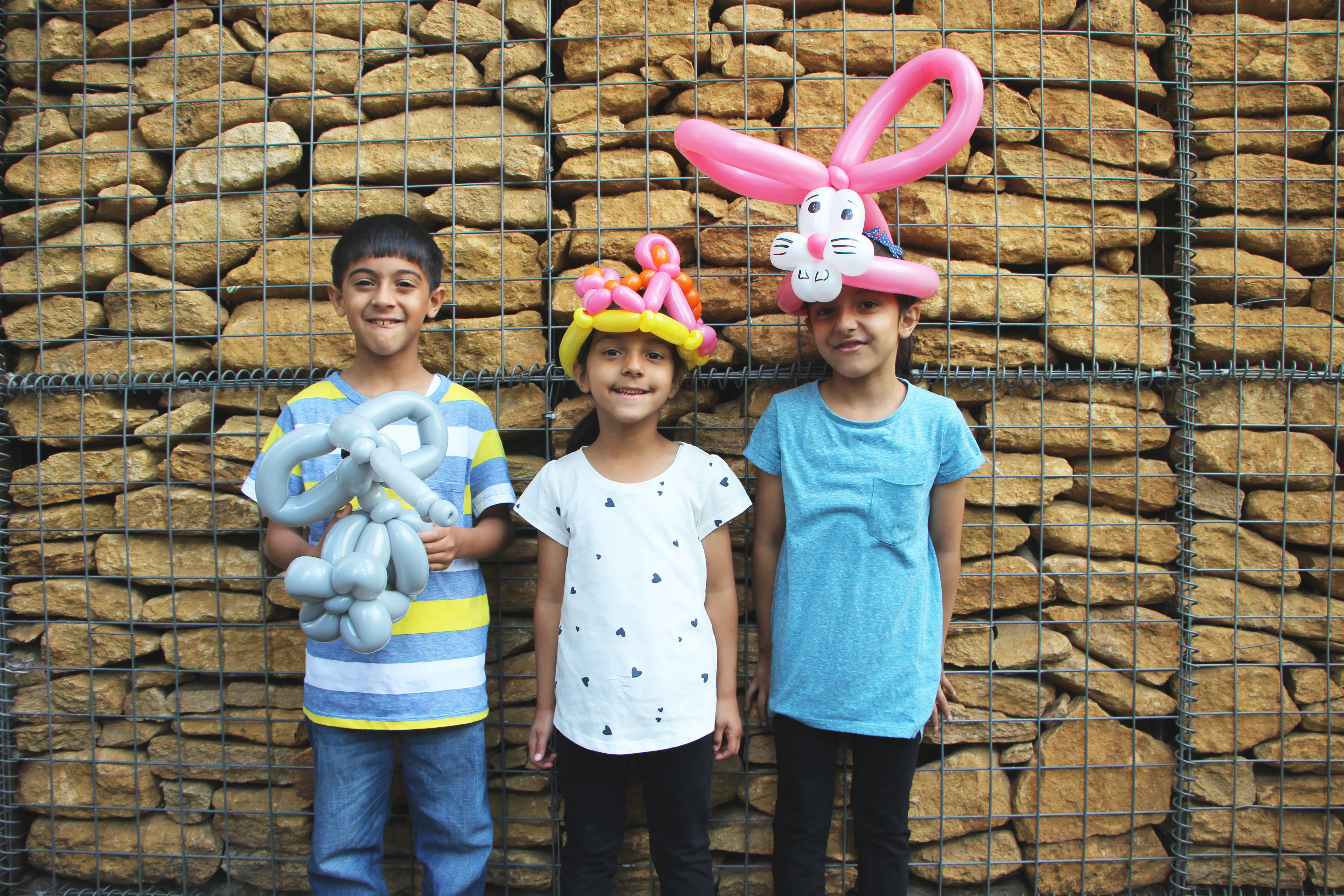 3 children in the courtyard, enjoying the family fun festival