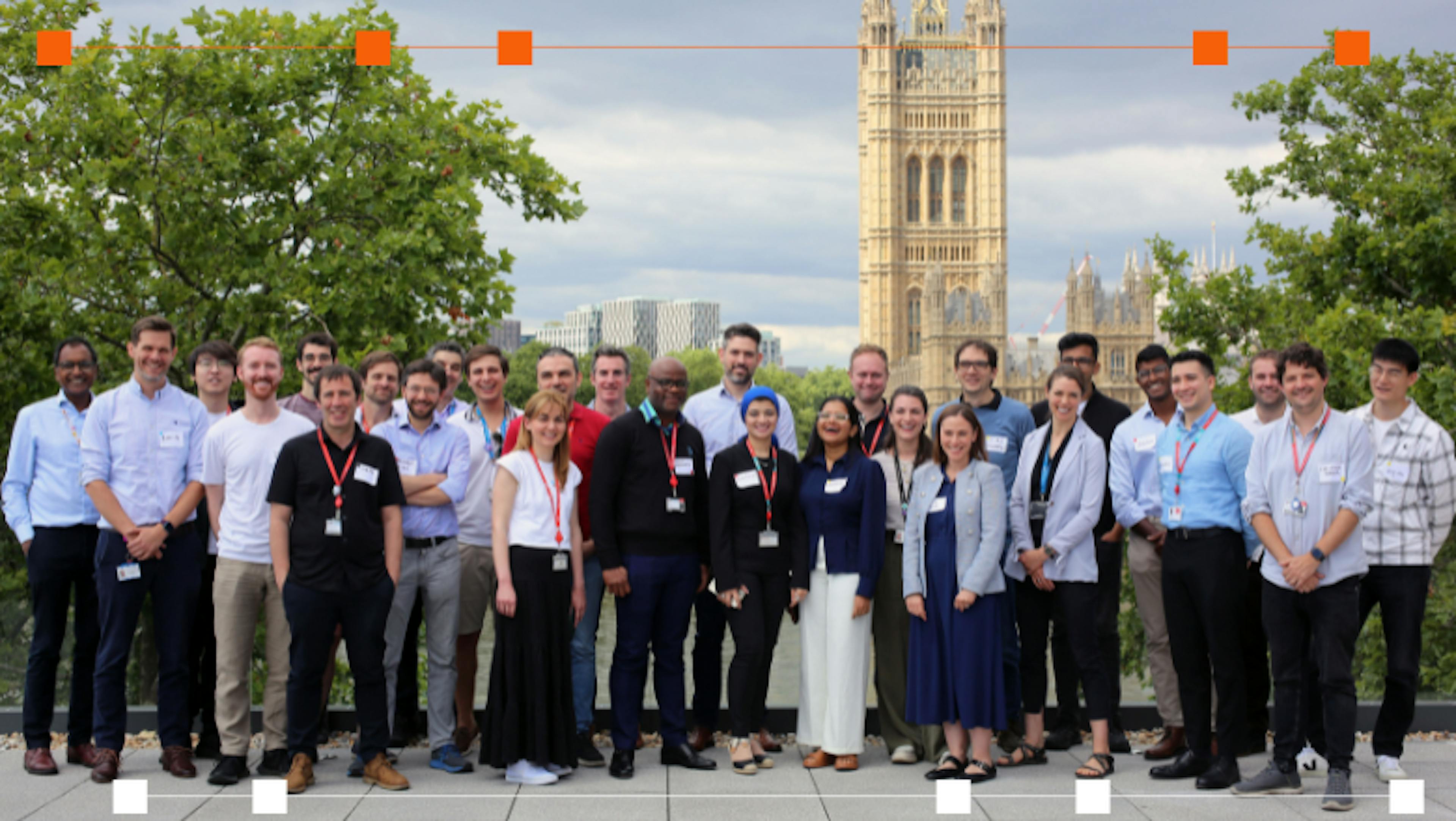 large group of people standing on terrace smiling