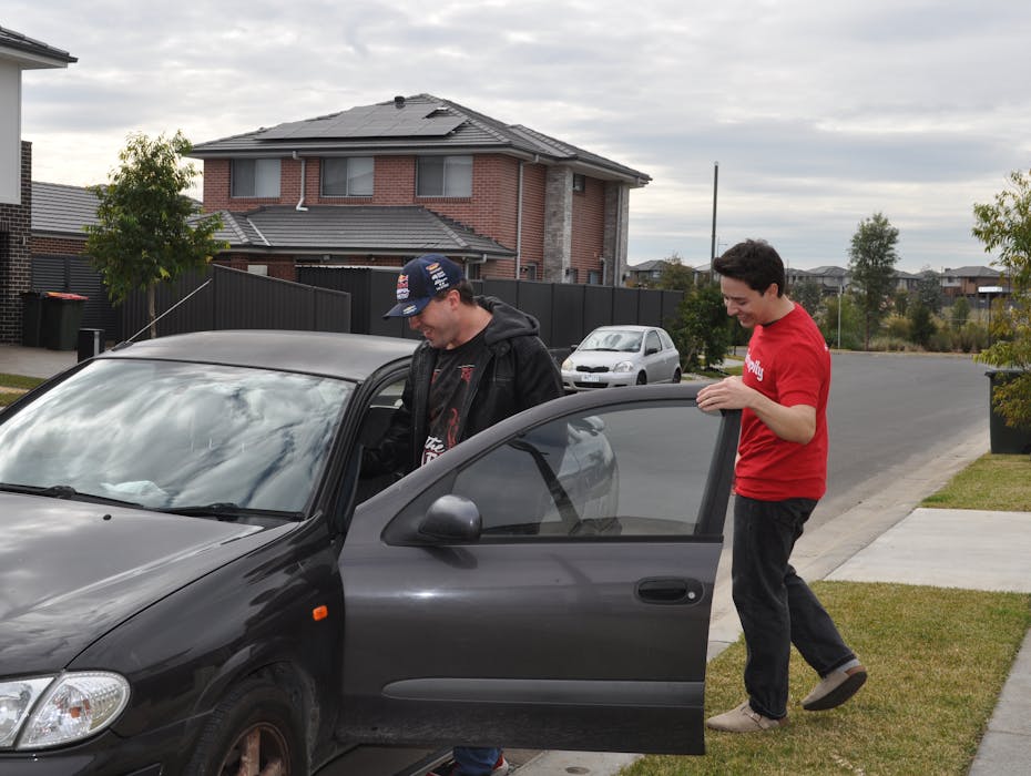 A Like Family Social Carer helps their Member get into a black car