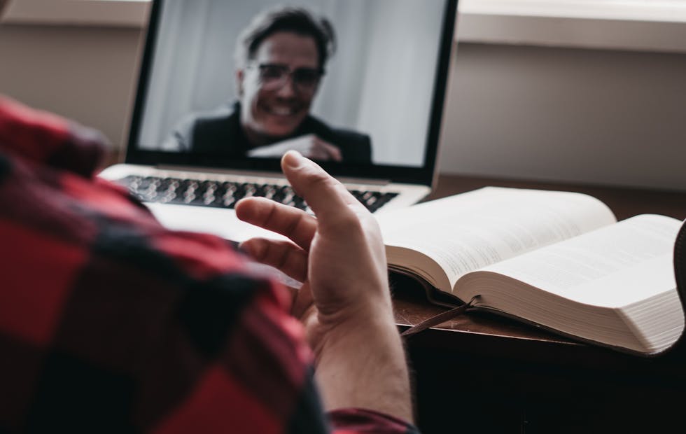 A man has a video call using his laptop