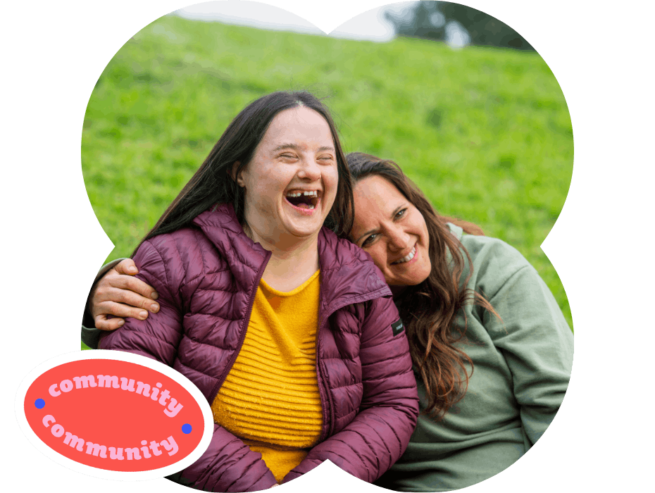 Member and Carer sitting with each other in the park, friendly embracing