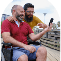 A Like Family Member and Carer watching something on their phone.