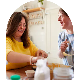 Like Family member and support worker baking together