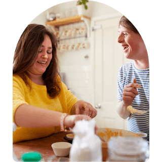 Like Family member and support worker baking together