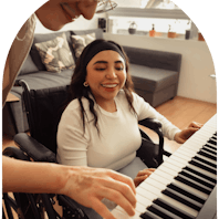 Member and carer playing keyboard together