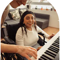 Member and carer playing keyboard together