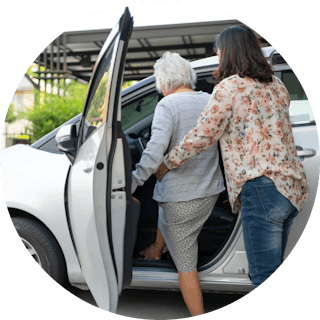 Like Family member entering a car with assistance from a support worker
