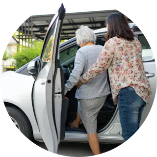 Like Family member entering a car with assistance from a support worker