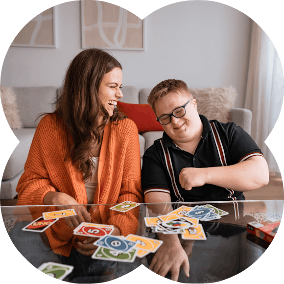 Like Family member playing uno with a support worker