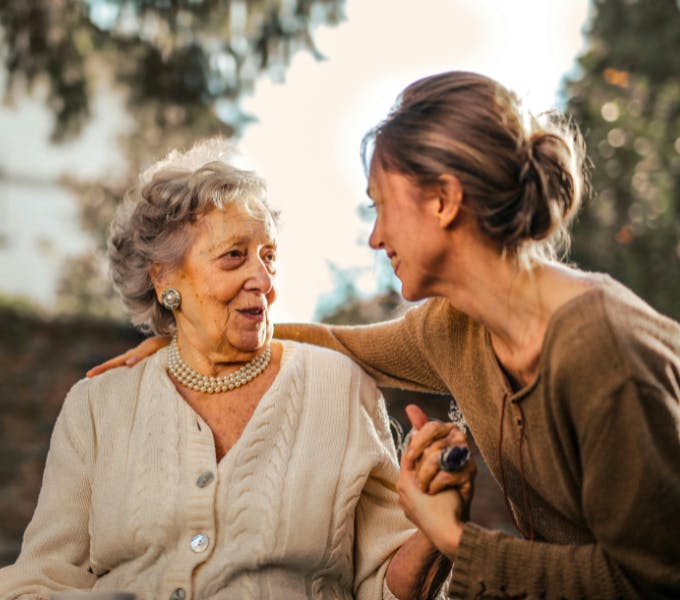 Elderly woman and support worker outdoors