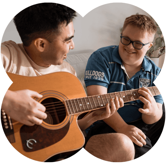 Like Family support worker playing guitar with a NDIS participant