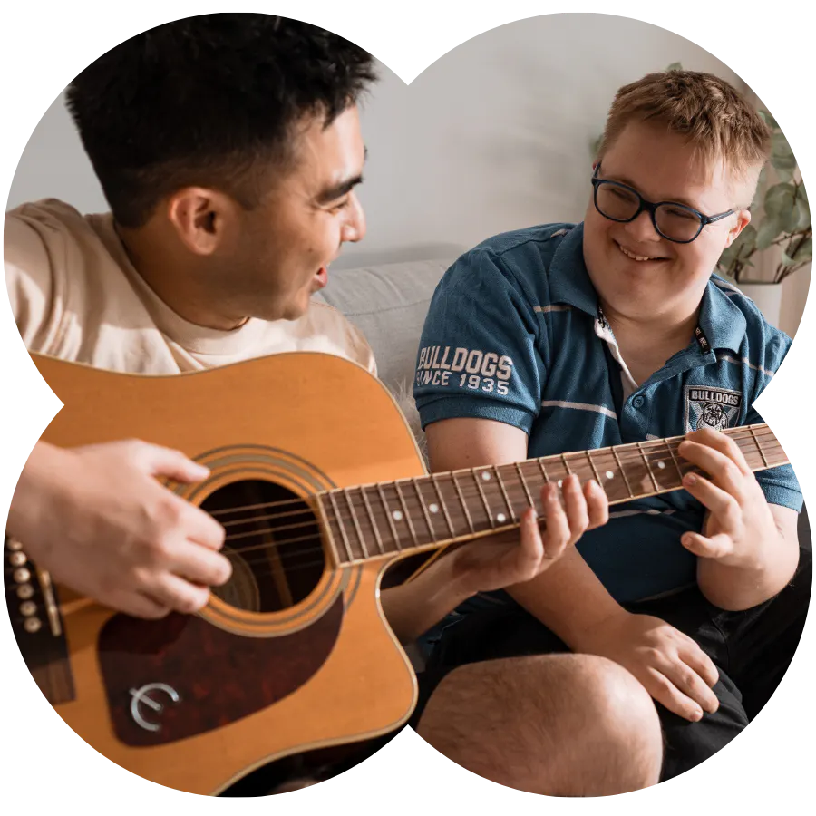 Like Family support worker playing guitar with a NDIS participant
