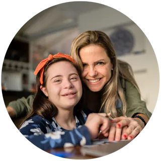 A Like Family Member (child) and their mum smiling at the camera