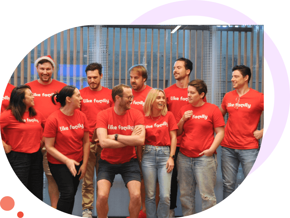 A group of 10 Like Family staff in red t-shirts