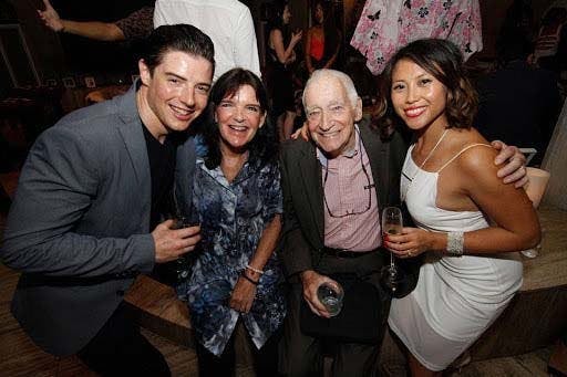 Mat, Jenna with Mat’s parents smiling in formal clothes