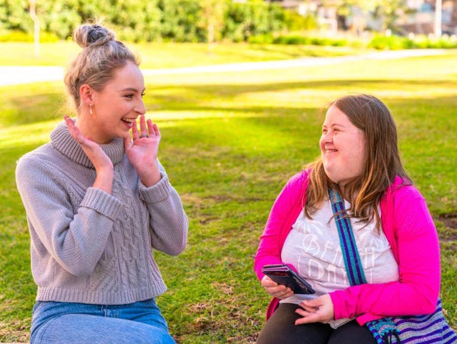 disabled women and carer talking in the park