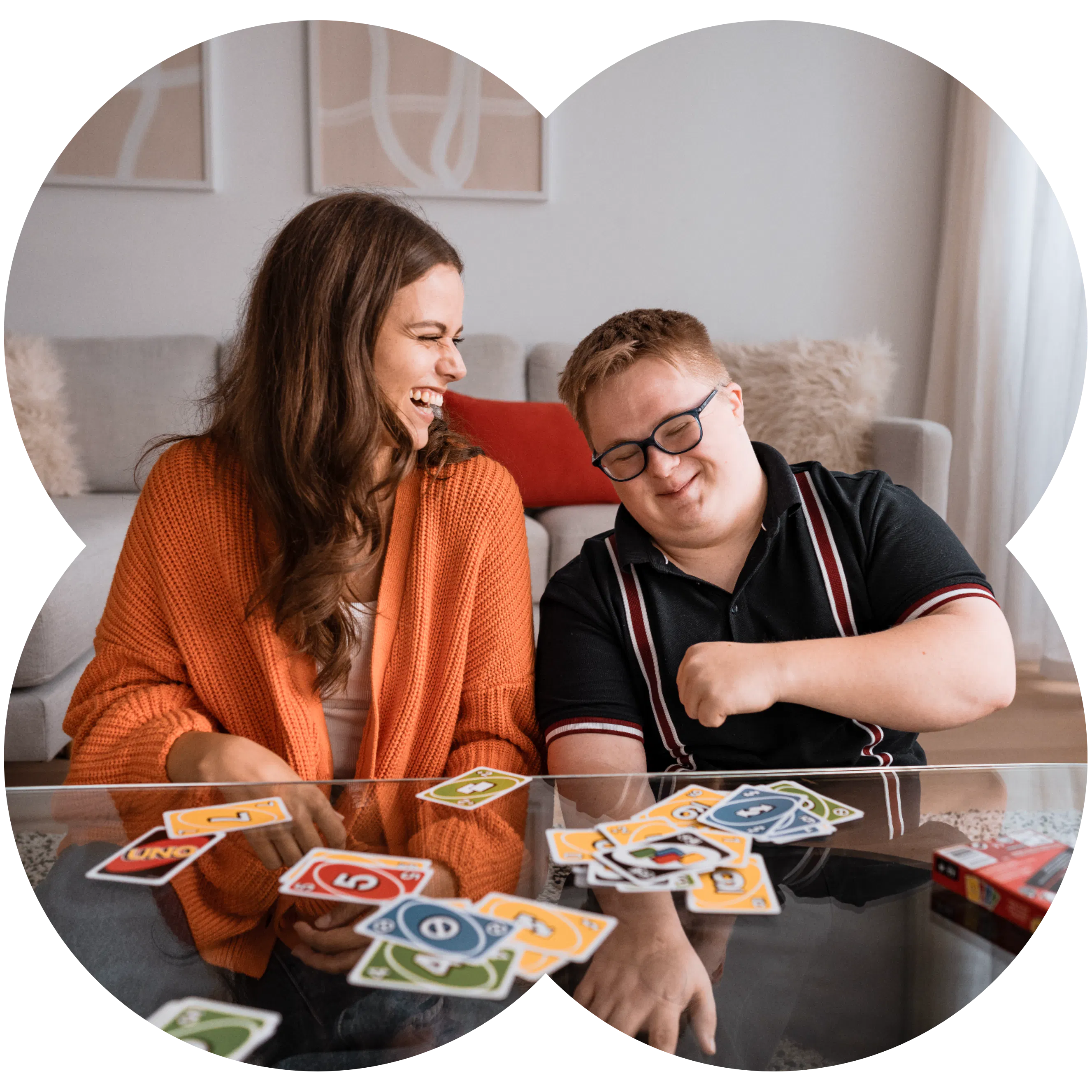 Social Carer Robyn and Member Benjamin playing UNO