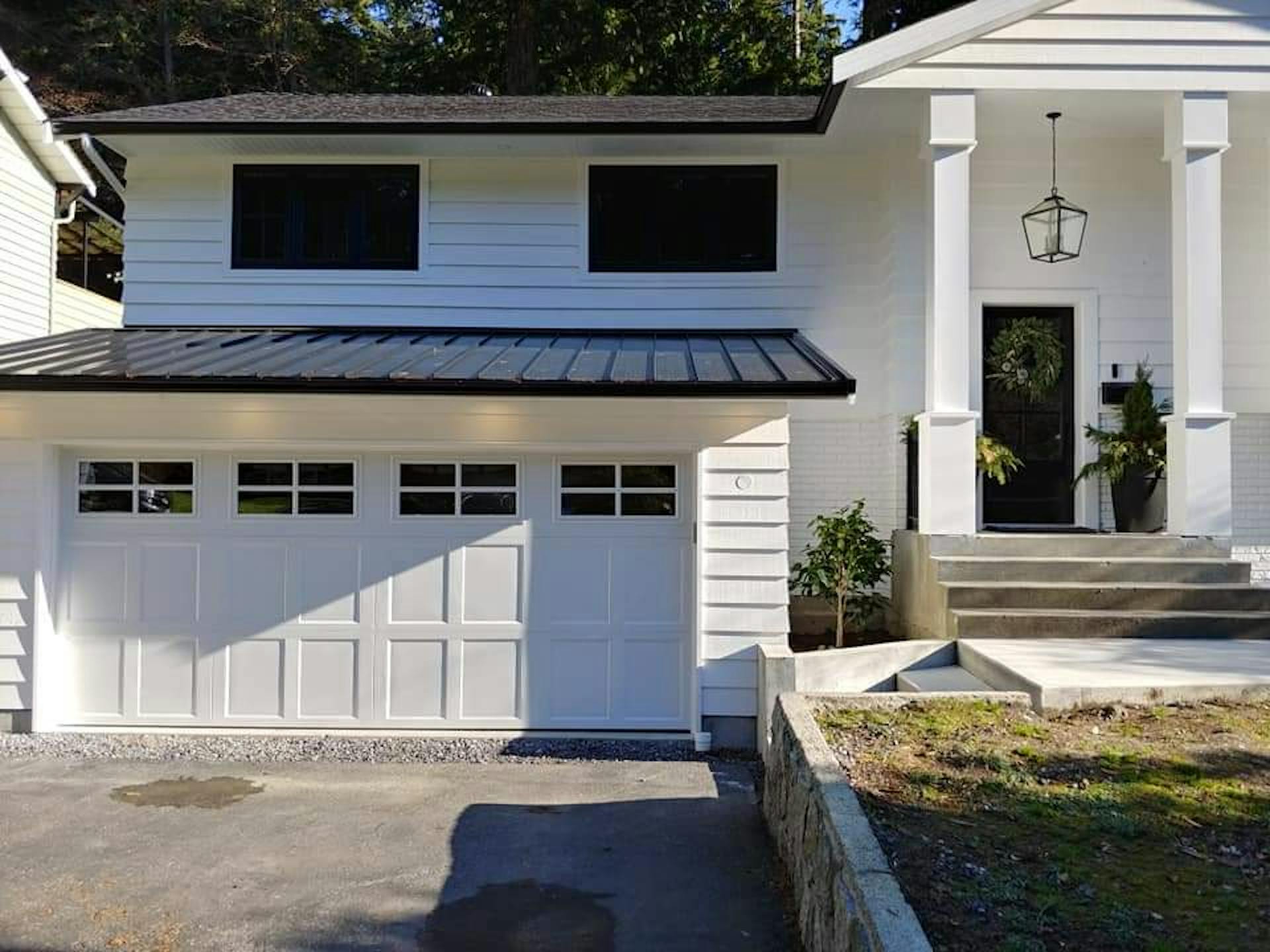 White paneled garage door with glass at top