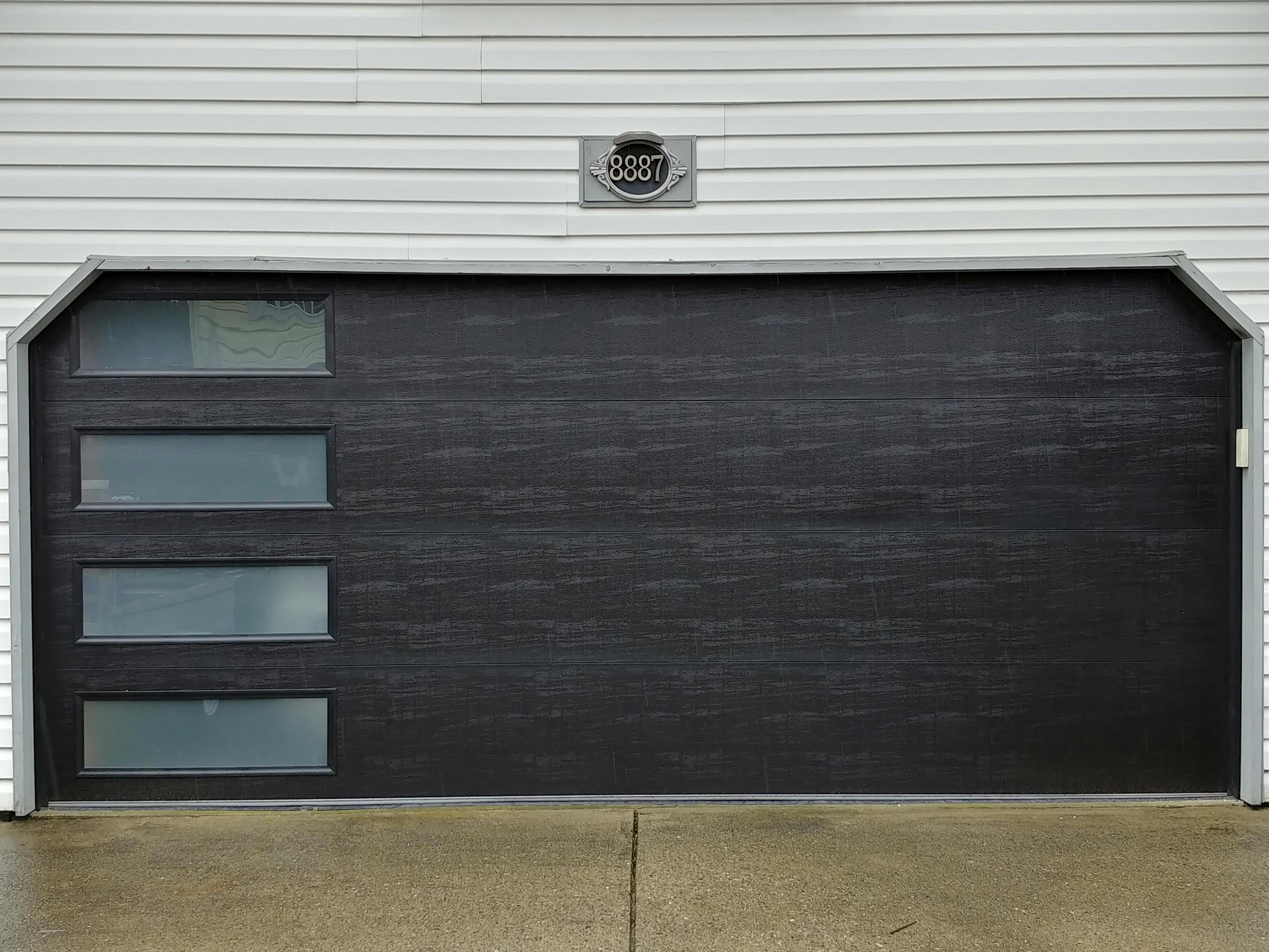 Dark garage door with glass panels on the left