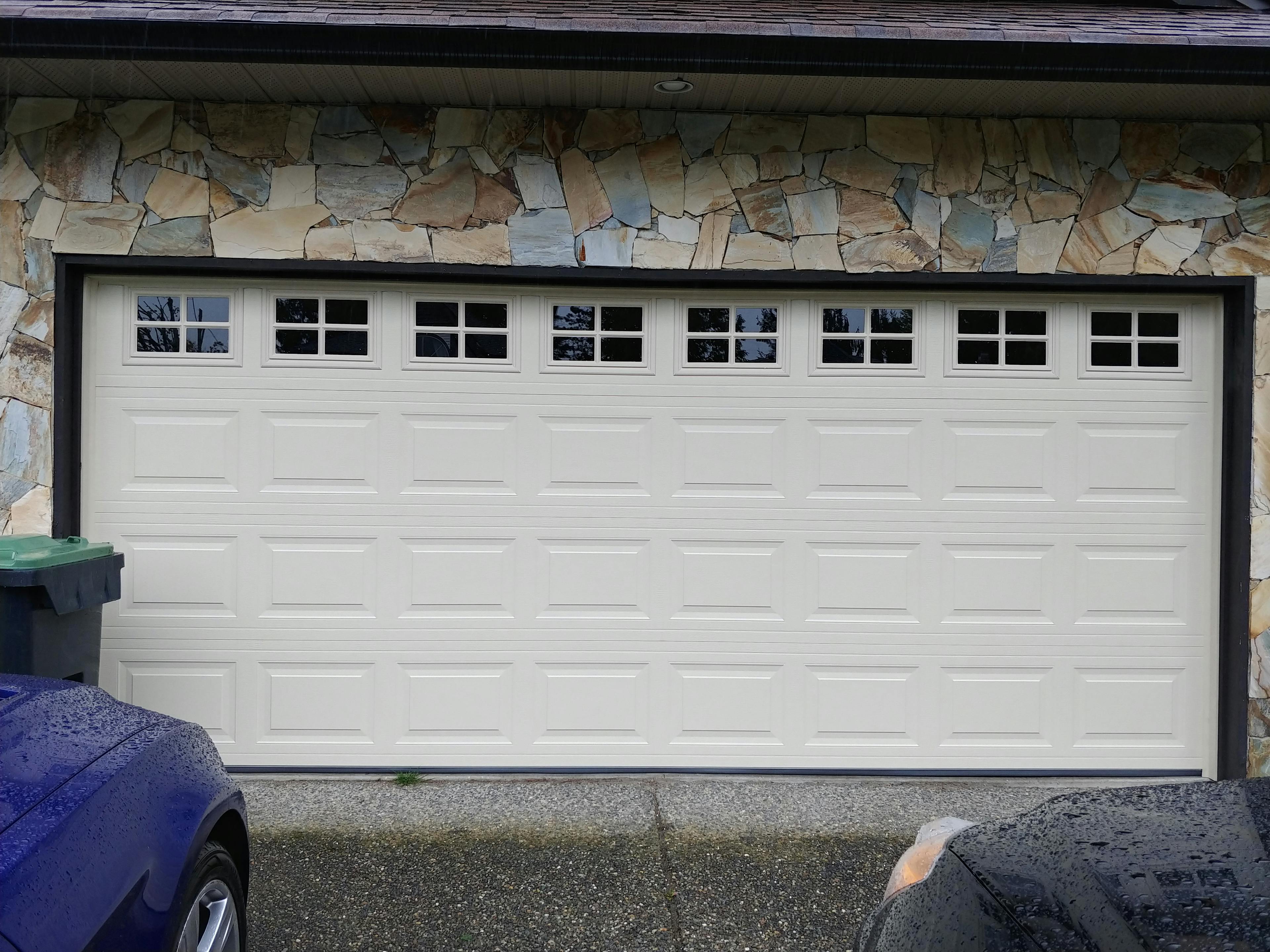 White garage door with small glass panels at the top