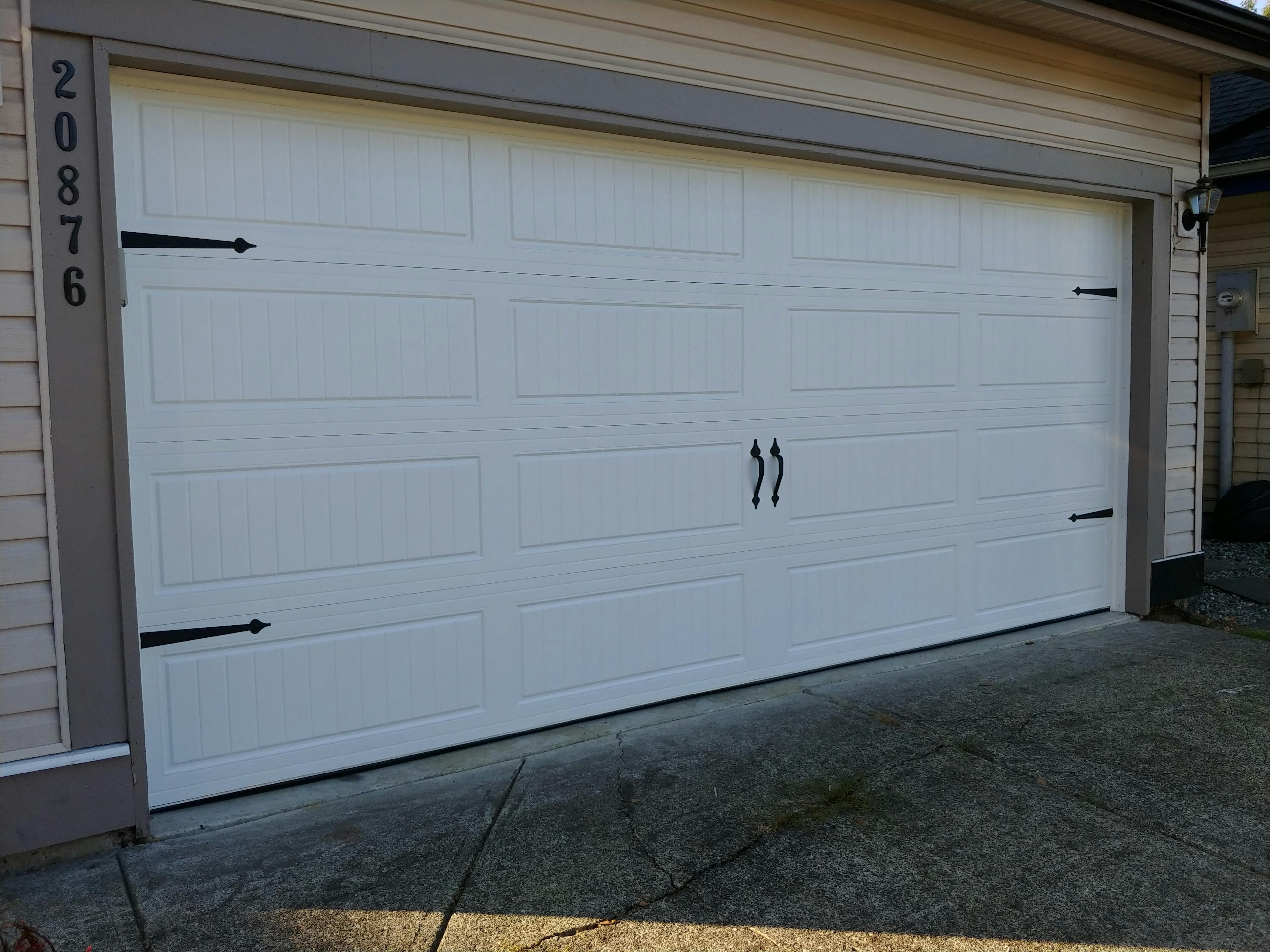 white garage door with black hardware