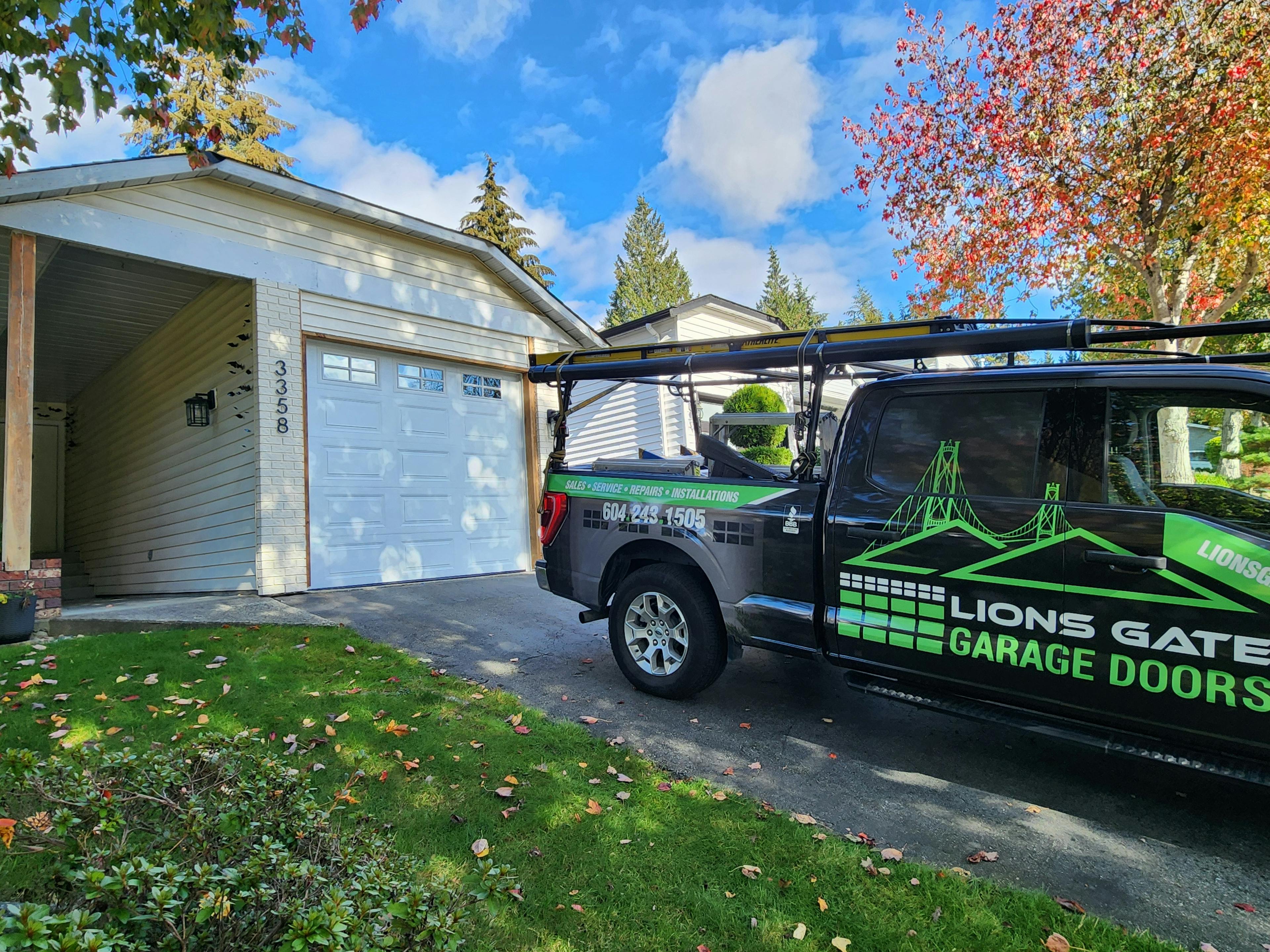 a Canadian-made 9x8 Steel-Craft Thermo-Craft, T-16 Panel garage door in crisp white with the Lions Gate Garage Doors truck in the foreground.