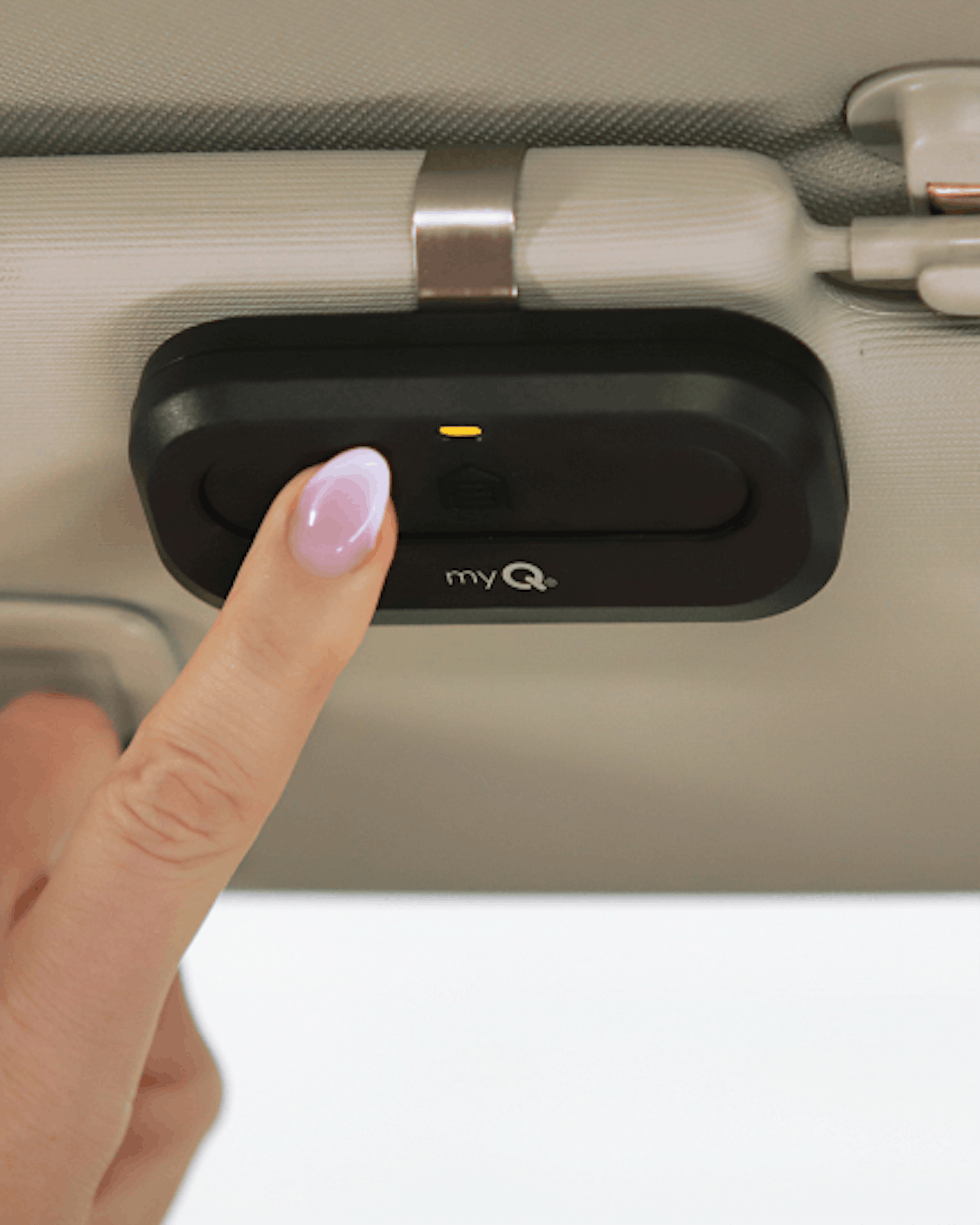 A finger pressing the LiftMaster 1-Button Remote