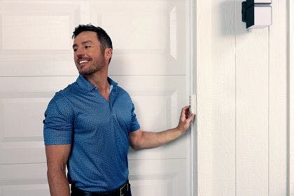 A man operating the LiftMaster L979S Wireless Keypad