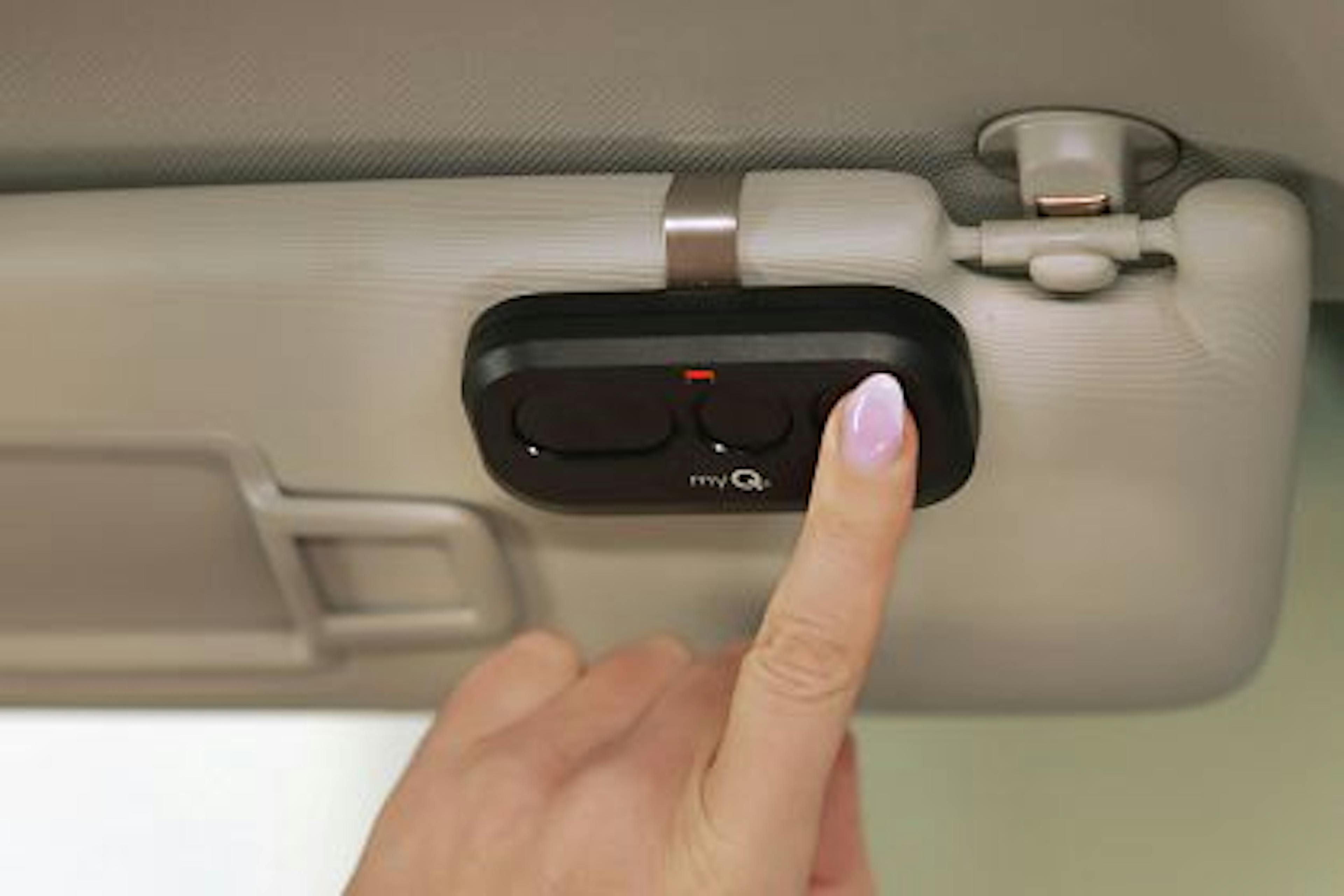 a woman's hand pressing the LiftMaster 3-Button Remote