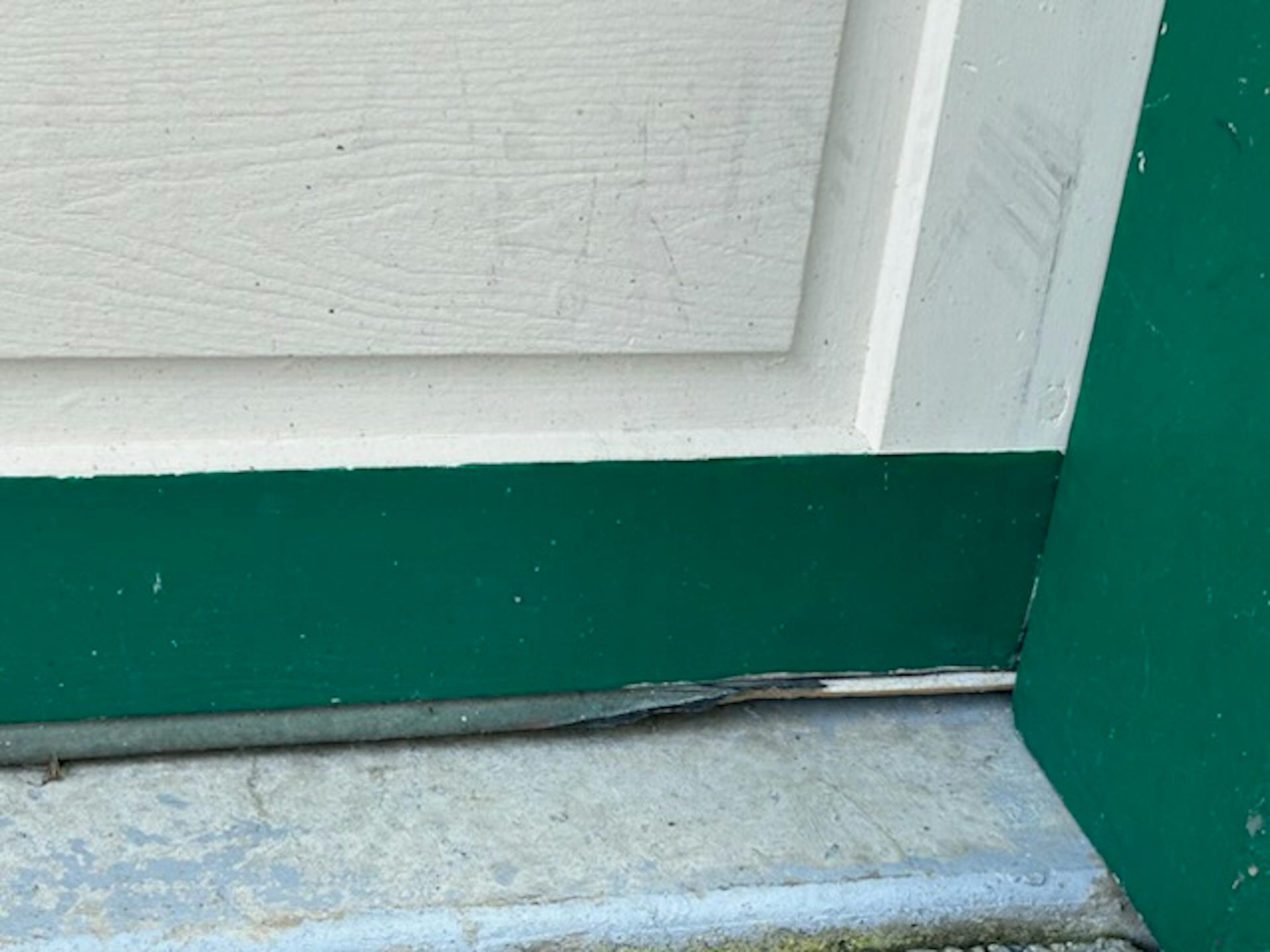 A gargedoor whose seal has been worn away so rodents can enter