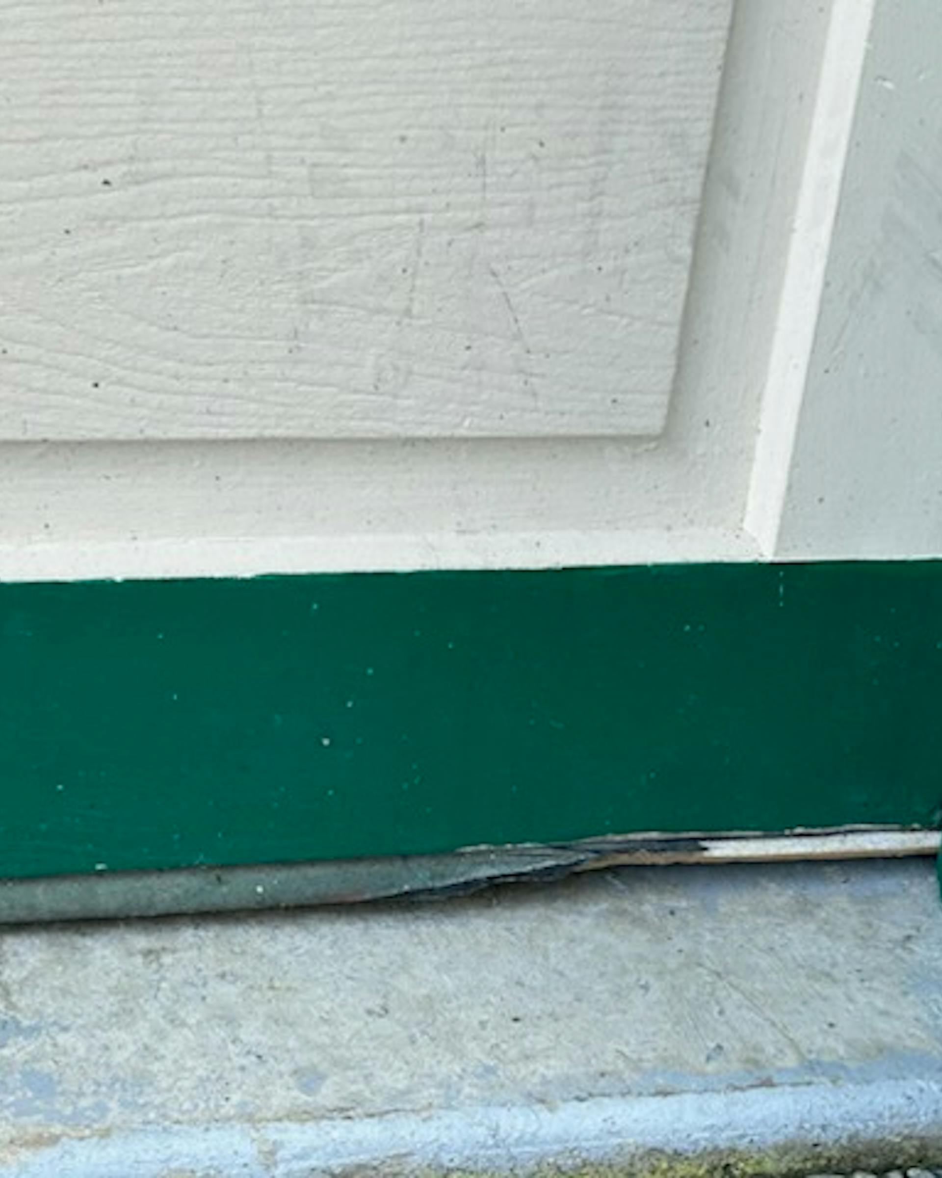 A gargedoor whose seal has been worn away so rodents can enter A gargedoor whose seal has been worn away so rodents can enter