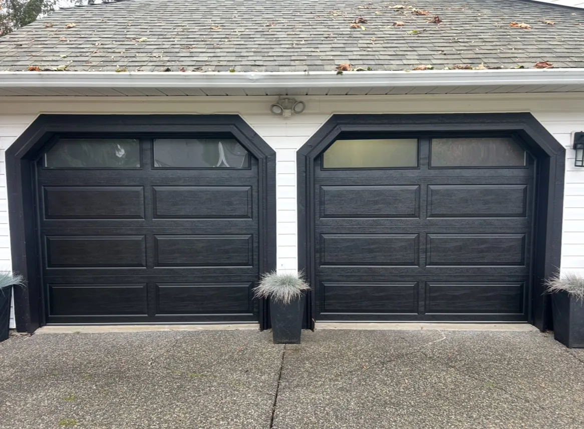 two 8x7 Northland R12 doors with a black wood grain finish and a classic Raised Ranch Panel design