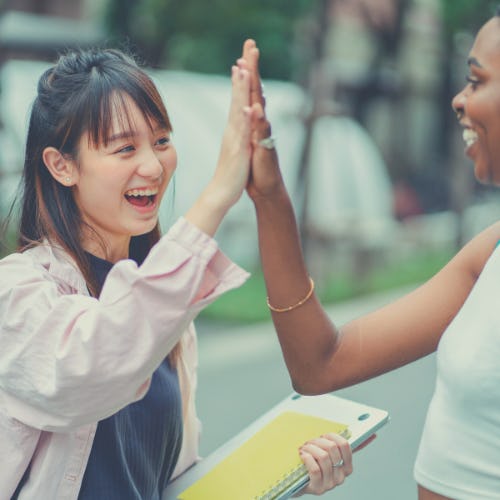 Photo of two people high-fiving