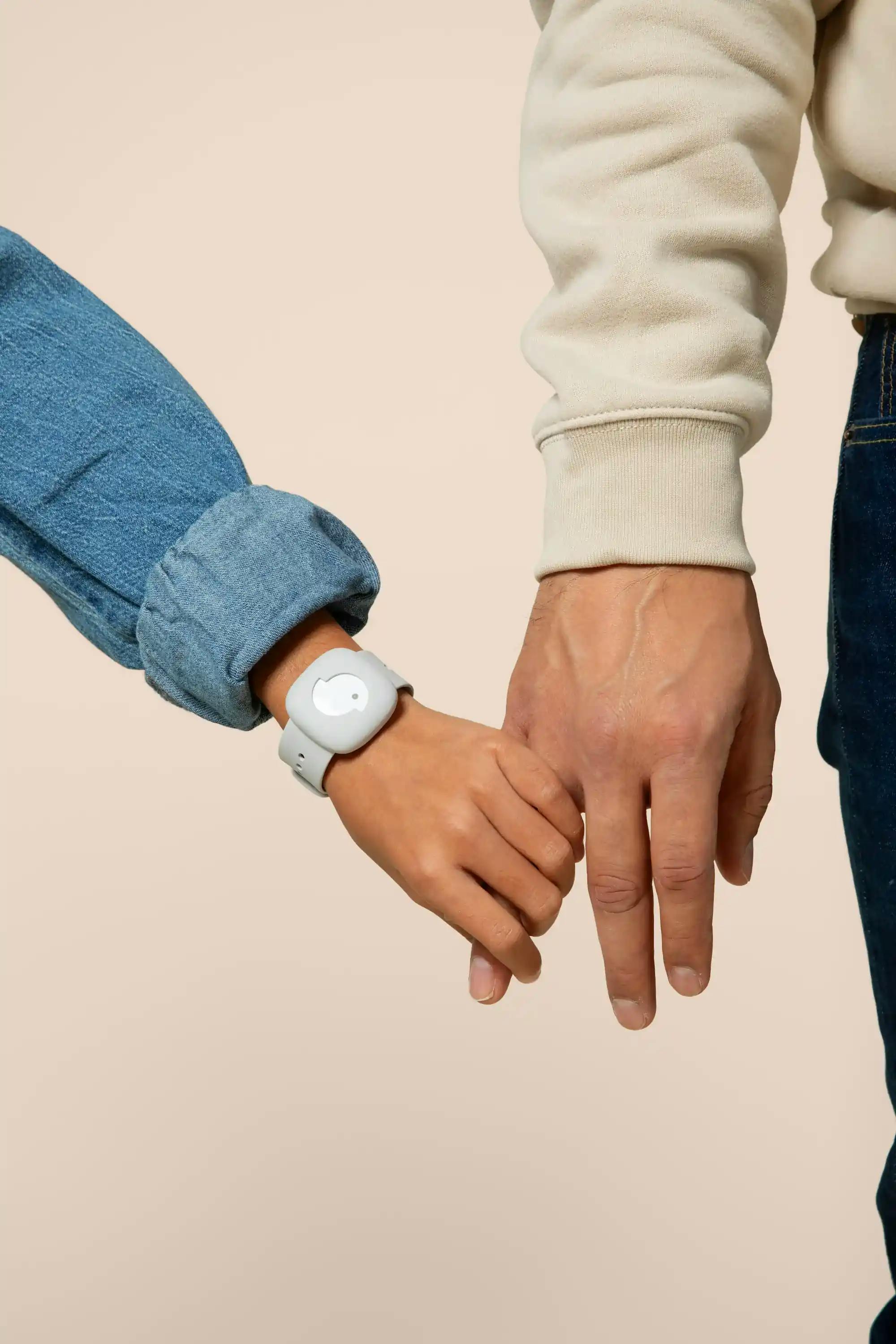 Kid holding their parent's hand