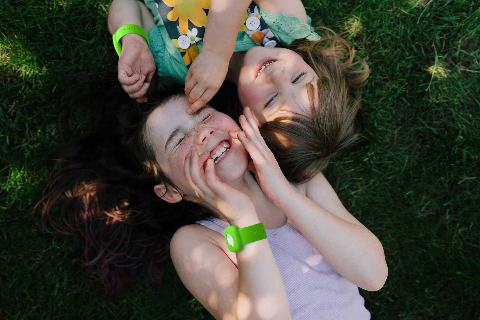 Girls wearing littlebird tracker in grass