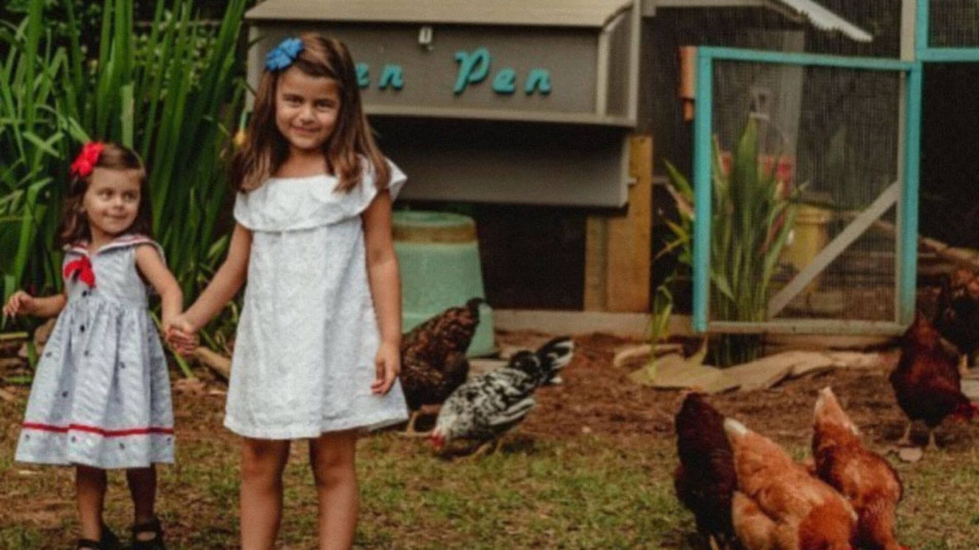 The daughters of Michelle helping her in the garden.