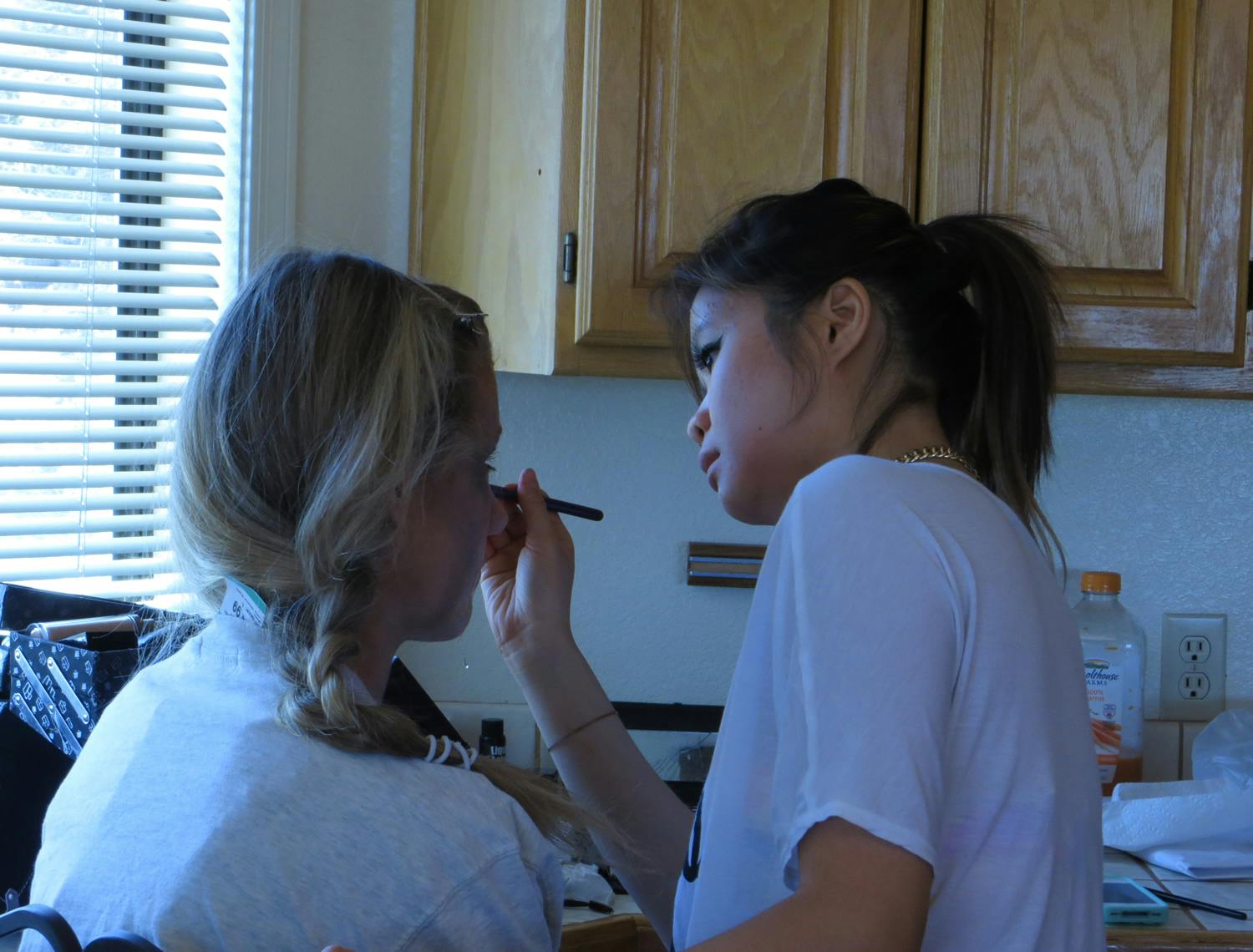 The makeup artist putting makeup on a zombie