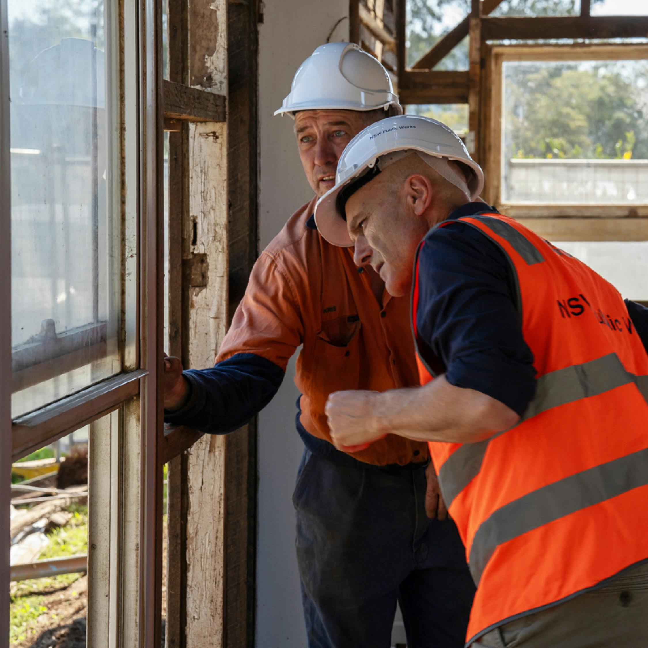 Kris Gardener and Berto Pandolfo inspecting timbers during the deconstruction process.
