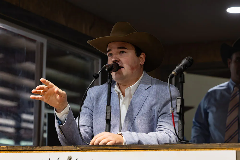 Kellan Bussell auctioneering in the block